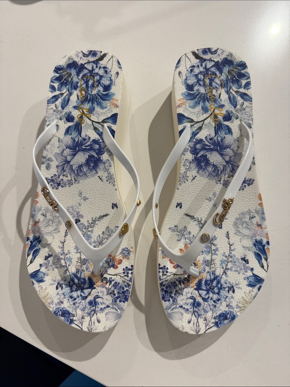 Camilla White-Strap Flip Flops with Blue Floral Print